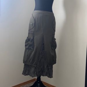 Green layered cargo midi skirt with pockets zippers and adjustable cords.
